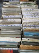 A TRAY OF VINTAGE POSTCARDS, sorted by subject / country