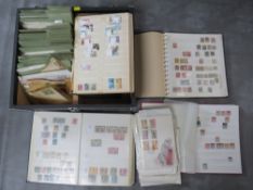 FOUR STAMP ALBUMS / STOCKBOOKS CONTAINING MAINLY SPANISH STAMPS, together with a collection of first