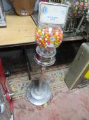 A VINTAGE FORD GUMBALL MACHINE & Co VENDING MACHINE, with label panel to the top, raised on a