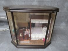 A BAY FRONTED ROOM BOX DIORAMA, depicting a Victorian bedroom