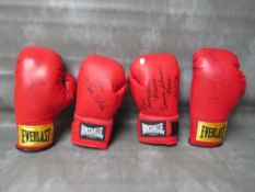 FOUR SIGNED BOXING GLOVES, to include Leon Spinks, Evander Holyfield, Ernie Shavers and Thomas