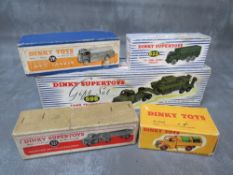 A TRAY CONTAINING FIVE BOXED VINTAGE DINKY VEHICLES, to include tank transporter and tank 698, AEC