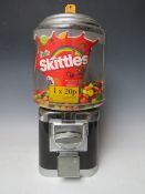 A VINTAGE STYLE METAL AND PLASTIC GUMBALL MACHINE, (currently containing Skittles), complete with