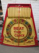 'BEAT THE CLOCK' A MID 20TH CENTURY PAINTED WOOD FAIRGROUND ROLL A BALL GAME BOARD, in red and