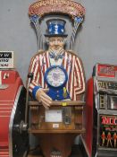 A VINTAGE 'SHAKE WITH UNCLE SAM' COIN OPERATED ARCADE MACHINE, cast iron bust and fittings on a