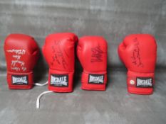 FOUR SIGNED BOXING GLOVES, to include Tim Witherspoon, James Bonecrusher Smith, Mike Tyson and Danny