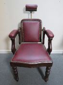 A LATE VICTORIAN BARBERS / DENTISTS CHAIR, with upholstered mahogany frame, adjustable centrifugal