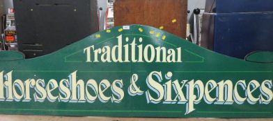 A MODERN FOLDING PAINTED WOOD FAIRGROUND SIGN, inscribed 'Traditional, Horseshoes and Sixpences',