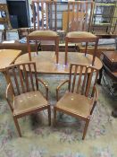 A MID CENTURY TEAK EXTENDING DINING TABLE & FOUR CHAIRS