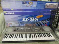 A BOXED YAMAHA PORTATONE EZ250i KEYBOARD WITH ACCESSORIES