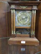 A VINTAGE MANTEL CLOCK WITH PENDULUM