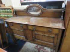 A VINTAGE OAK MIRROR BACK SIDEBOARD
