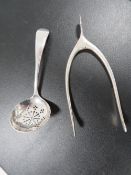 A PAIR OF HALLMARKED SILVER WISHBONE SUGAR TONGS TOGETHER WITH A HALLMARKED SILVER SIFTER SPOON (2)