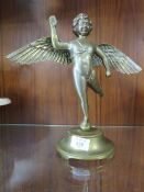 A BRASS TABLE FIGURE OF A CHERUB WITH ARTICULATED WINGS