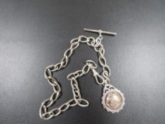 AN ANTIQUE SILVER GENTS POCKET WATCH ALBERT CHAIN