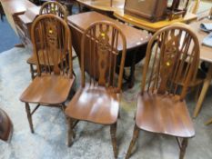 AN OLD CHARM OAK DROPLEAF TABLE WITH FOUR WHEELBACK CHAIRS