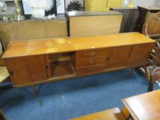 A MID CENTURY TEAK SIDEBOARD WITH SLIDING DOORS - W 213 CM A/F