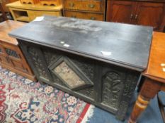 AN ANTIQUE OAK CARVED COFFER WITH MIRROR DETAIL - W 110 CM