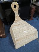 AN UNUSUAL WICKER ROCKING CHAIR