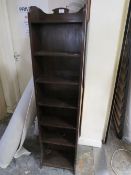 A TALL OAK OPEN BOOKCASE