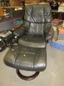 A black leather stressless (Ekornes) armchair and footstool