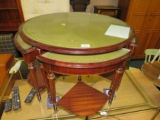 A modern mahogany circular nest of tables