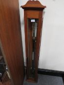 A WOODEN CASED BAROMETER WITH KEY