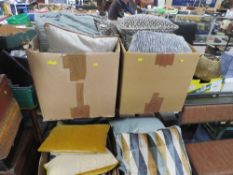 FOUR TRAYS OF ASSORTED CUSHIONS IN VARYING COLOURS, SIZES AND DESIGNS