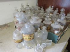 A QUANTITY OF LABELLED CLEAR APOTHECARY BOTTLES