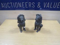 A PAIR OF CAST BRONZE STYLE EASTERN DOGS OF FO TYPE STATUETTES