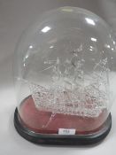 A HAND-BLOWN GLASS GALLEON UNDER A GLASS DOME