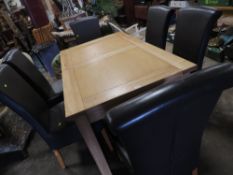 A modern light oak, extending dining table and six leather style dining chairs