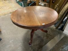 An antique mahogany tilt top circular centre table with carved decoration to the legs A/F
