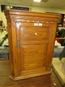 AN ANTIQUE OAK HANGING CORNER CUPBOARD WITH MOTHER-OF-PEARL INLAY