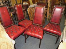 A set of four mahogany reproduction oxblood, red dining chairs