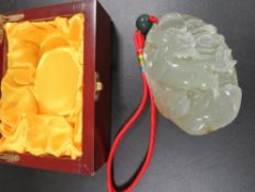 A CHINESE CARVED HORSE GOOD LUCK STONE WITH HANGING LOOP IN MODERN BOX