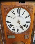 A WALL MOUNTED NATIONAL TIME RECORDER OAK CASED CLOCKING IN CLOCK, H 119 cm