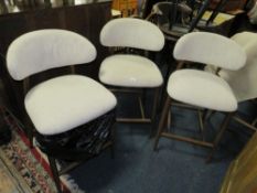 A set of three modern upholstered bar/kitchen stools