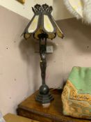 A large 20th century Tiffany style table lamp model as a naked lady holding the shade standing on