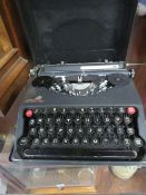 A VINTAGE EMPIRE PORTABLE TYPEWRITER