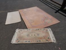Three 20th century woollen rugs, including one large example
