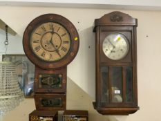 An antique American inlaid wall clock together with an Edwardian oak placed wall clock, both as