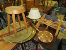 A woollen rug, a hanging tapestry, a brass top table, warming pan, lamp, stool, etc.