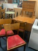 A mid-century teak drop leaf dining table with four chairs and two drawer cabinet