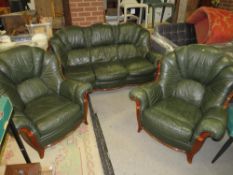 A green leather, three piece lounge suite