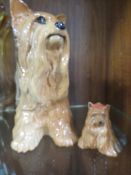 A BESWICK FIRESIDE MODEL OF A YORKSHIRE TERRIER TOGETHER WITH A SMALLER EXAMPLE