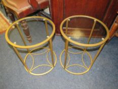 A pair of modern glass and metal lamp tables