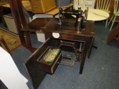 A vintage singer electric sewing machine in oak cabinet
