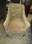An antique upholstered square armchair