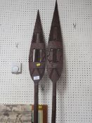 TWO MELANESIAN OR POLYNESIAN WOODEN CEREMONIAL PADDLECLUB SPEARS WITH CARVED DECORATION, THE LONGEST